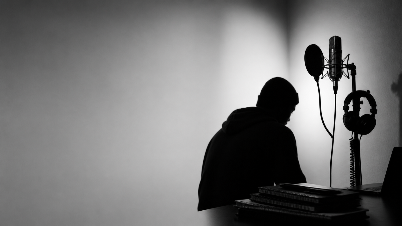 Black and white studio scene with microphone and headphones